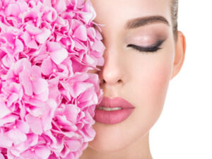 young-beautiful-woman-with-flowers-near-face-small